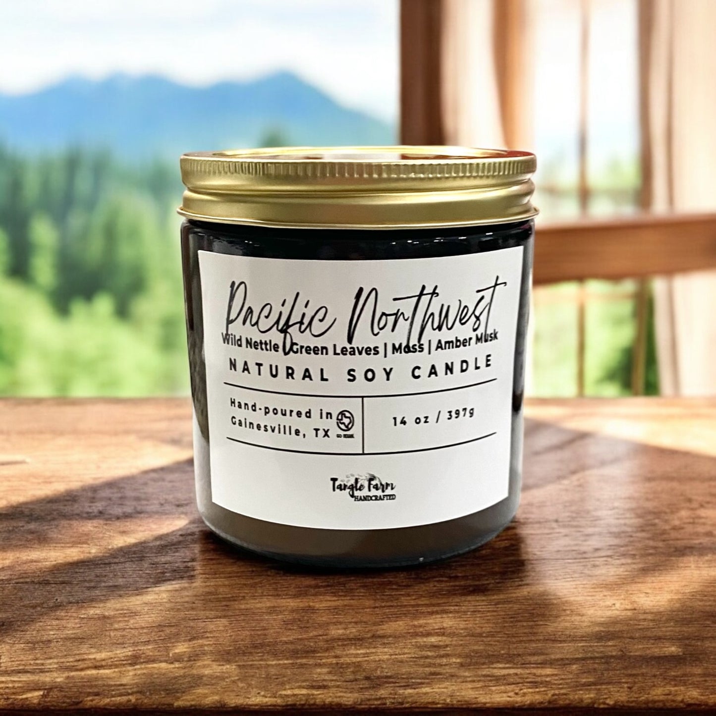 Pacific Northwest 14oz soy candle scented with notes of wild nettle, green leaves, moss, amber musk.