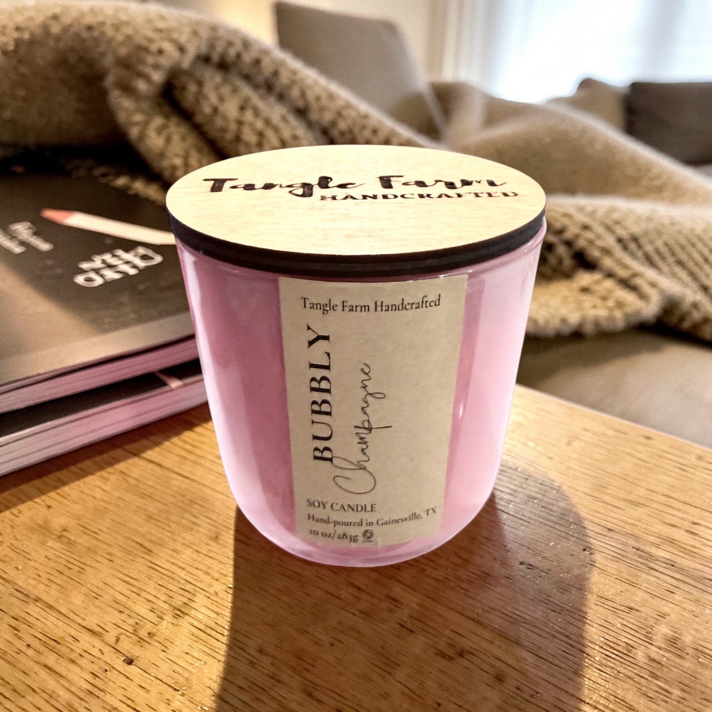 Bubbly champagne soy candle with a delightful champagne toast scent, blending sweet berries and sparkling champagne, housed in a colorful Sefarina candle container. 10oz