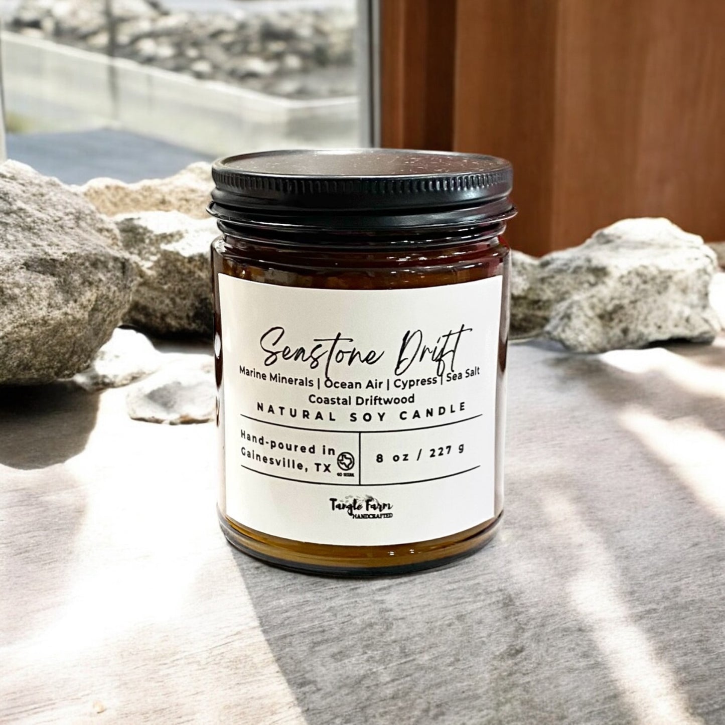 Seastone drift 8oz soy candle with marine waters, sea salt, cypress, ocean air, coastal driftwood.
