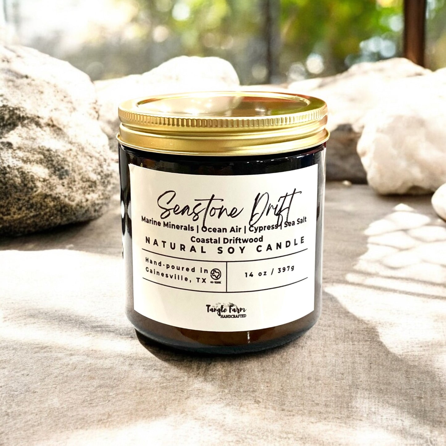 Seastone drift 14 oz soy candle with marine waters, sea salt, cypress, ocean air, coastal driftwood.
