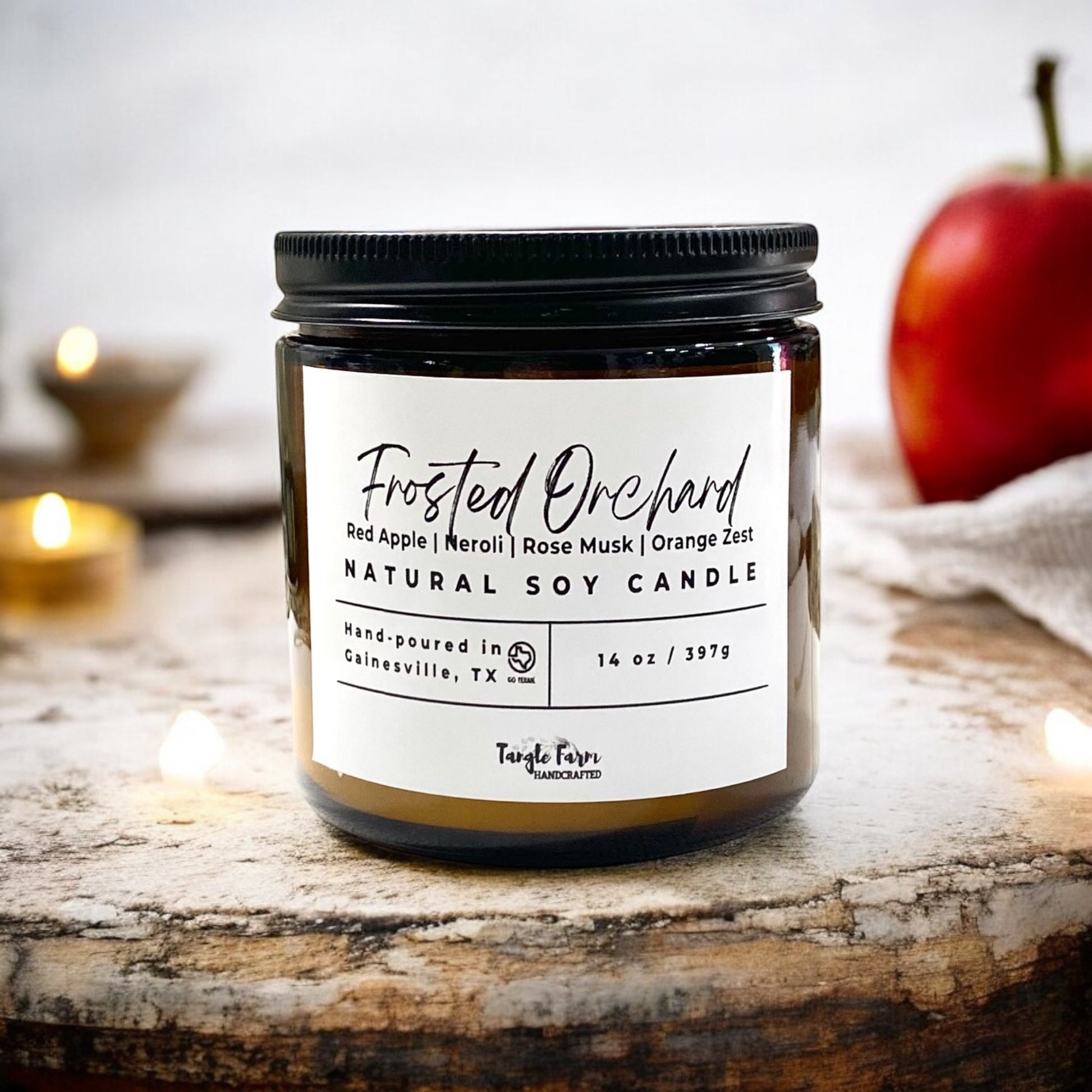 Frosted orchard 14 oz soy candle with scent of red apples, neroli, rose musk and orange zest.