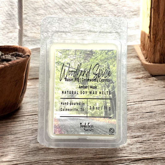 Woodland Spice wax melt with notes of raisin, fig, cedarwood, cypress, amber and musk.