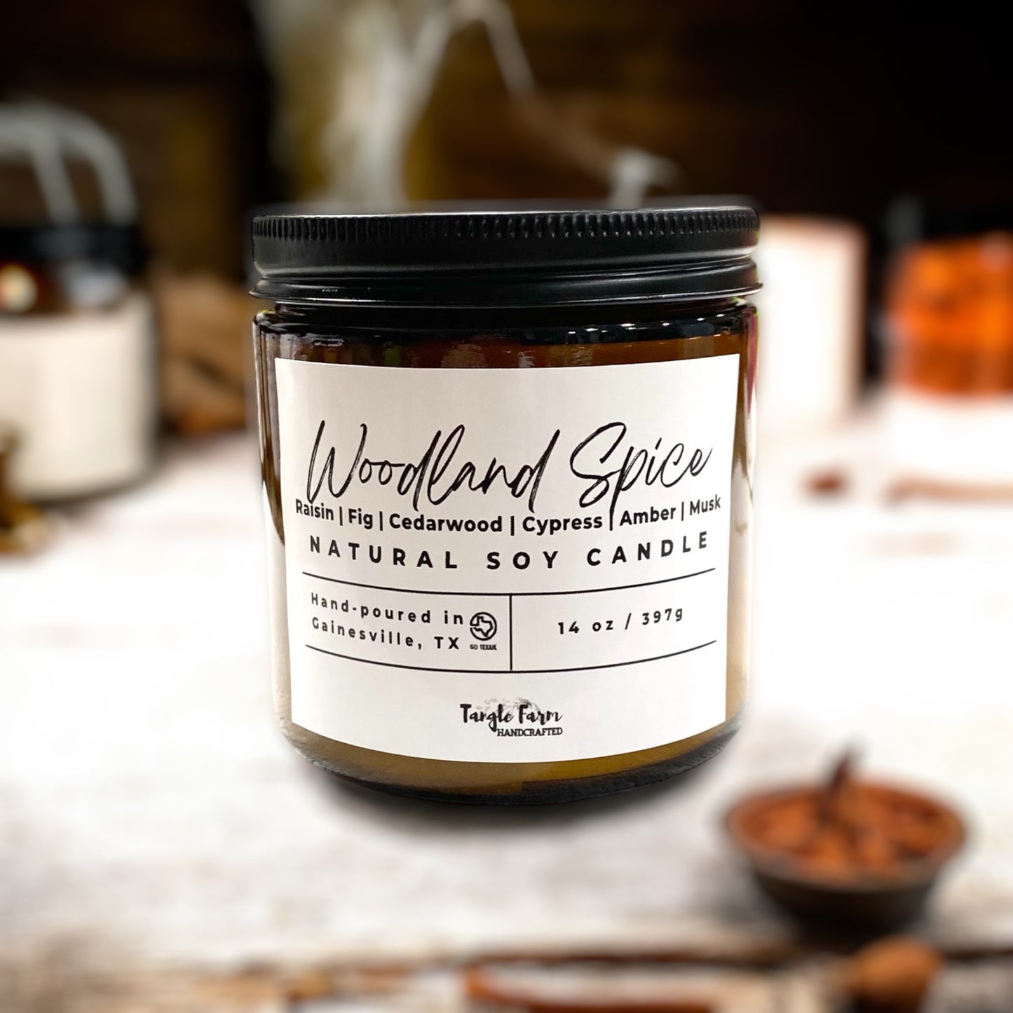 Woodland spice soy candle in amber jar with notes of raisin, fig, cedarwood, cypress and amber and musk.