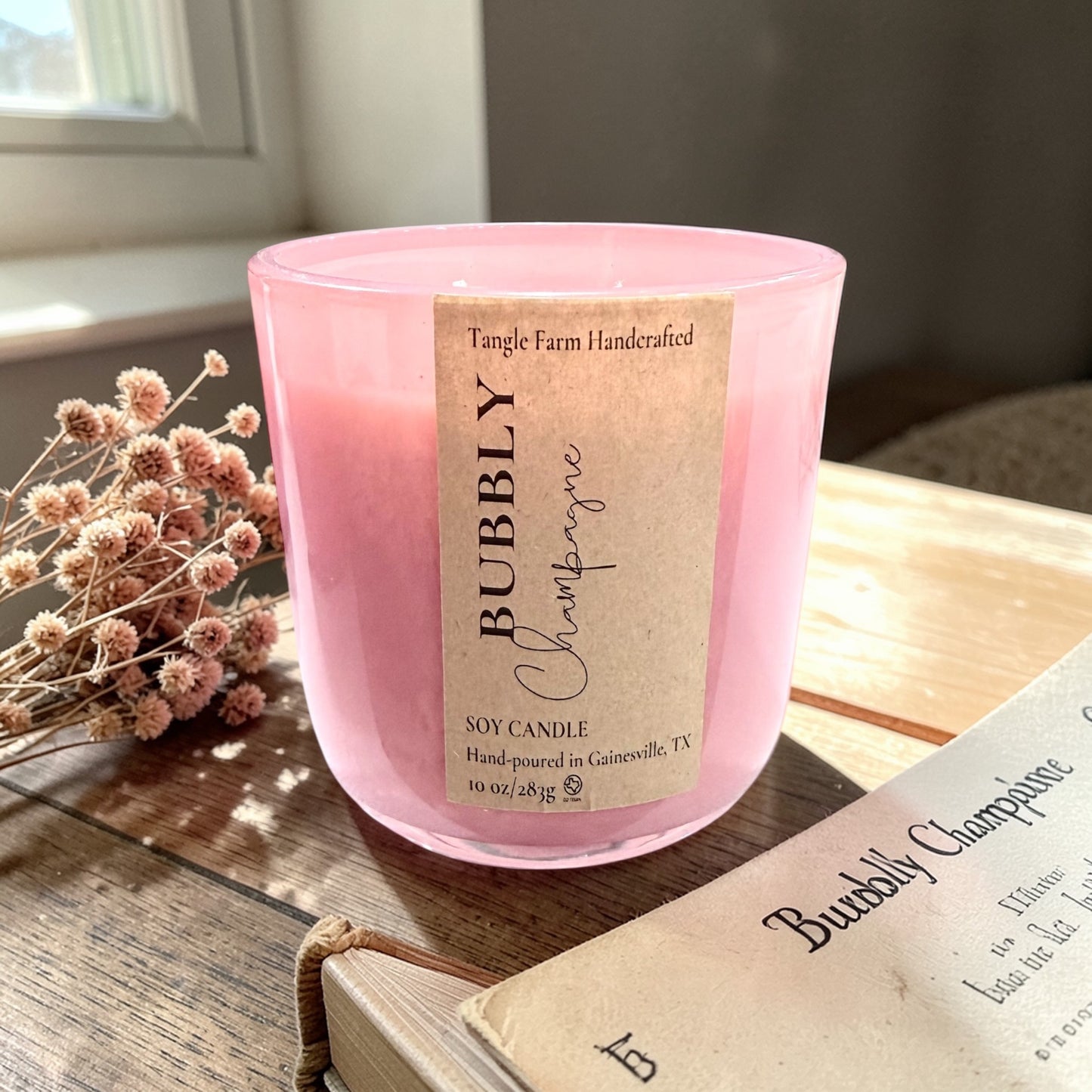 Bubbly champagne soy candle with a delightful champagne toast scent, blending sweet berries and sparkling champagne, housed in a colorful Sefarina candle container. 10oz