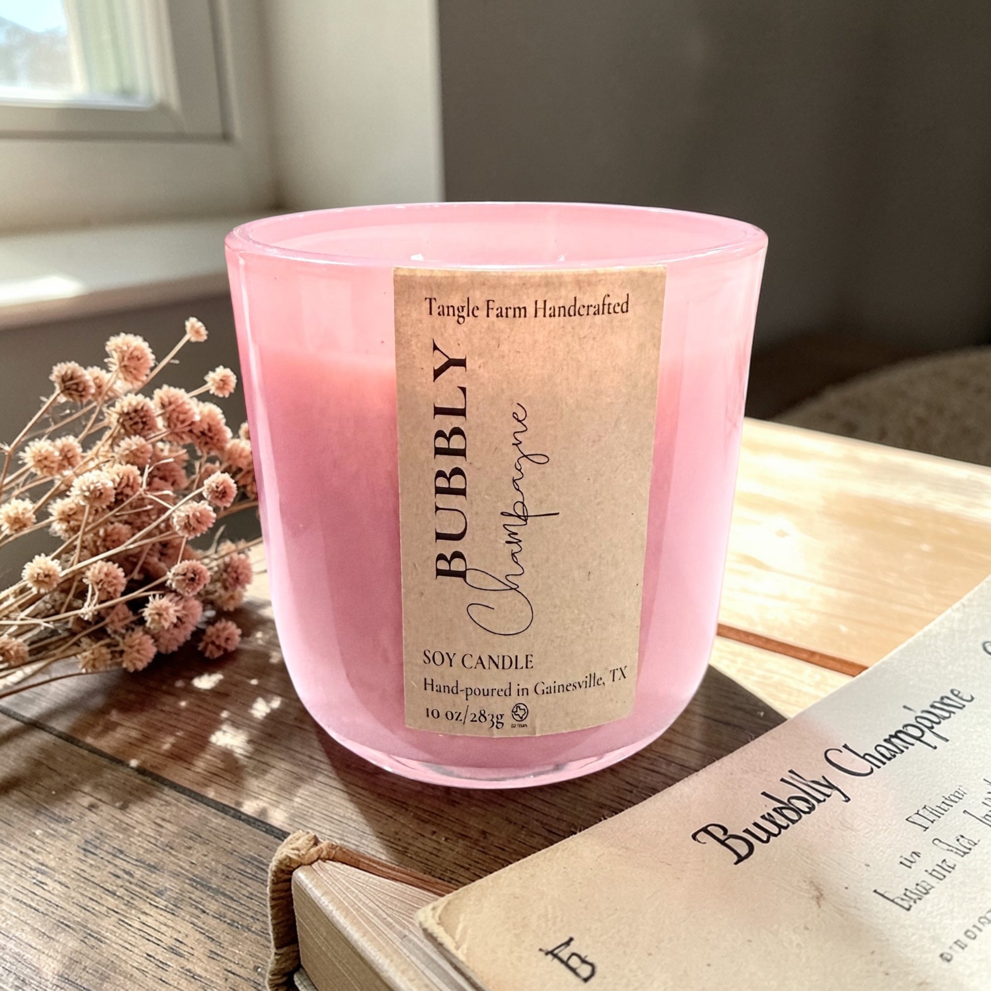 Bubbly champagne soy candle with a delightful champagne toast scent, blending sweet berries and sparkling champagne, housed in a colorful Sefarina candle container. 10oz